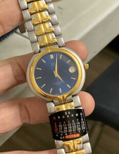 Givenchy Villandry Reg. Model, Navy Blue Dial w/ Gold Tone Hands & Indexes & w/ Date Window, Quartz Movement, Gold Bezel w/ Two Tone Stainless Steel Bracelet w/ Folded Clasp  | EKT0409